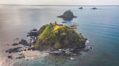 Scenic view of rock formation in sea against sky