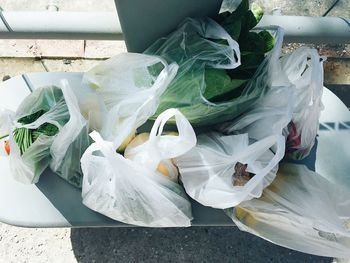 High angle view of vegetables in plastic bags on table