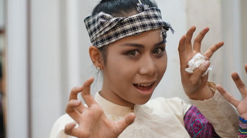 Portrait of smiling young woman wearing mask