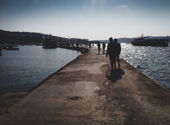 Rear view of man walking on beach