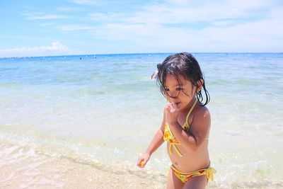 Girl in bikini enjoying on shore