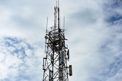 Low angle view of communications tower against sky