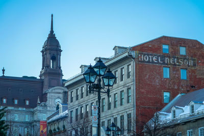 Low angle view of buildings against blue sky