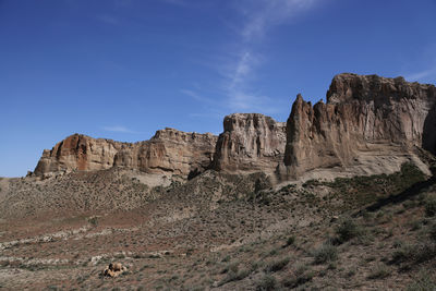 Low angle view of rock formations against sky