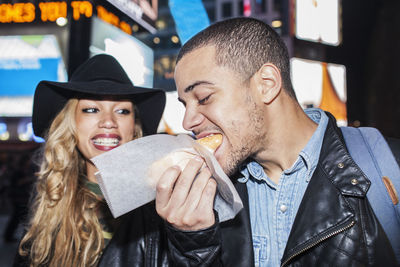 Young couple eating street food