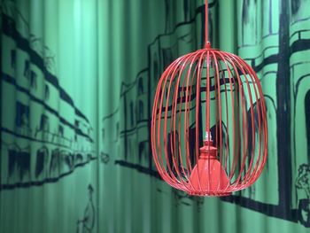 Close-up of illuminated lantern hanging in cage