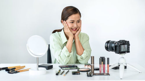 Portrait of young businesswoman working at table