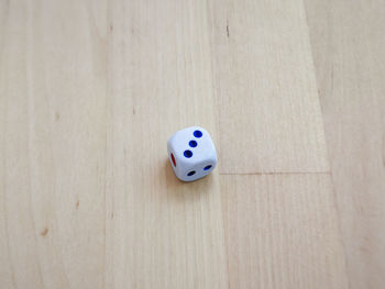 High angle view of dice on hardwood floor at home