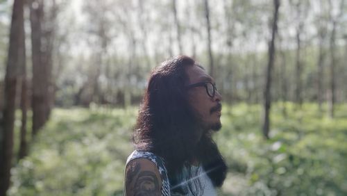Young woman standing in front of two women