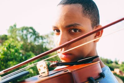 Portrait of teenage boy playing violin