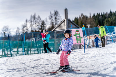 Full length of children on snow during winter
