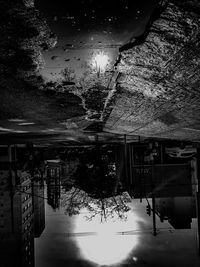 Reflection of building in puddle on street