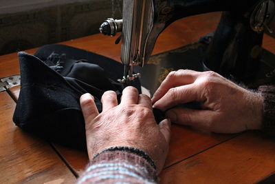Cropped hand of tailor working in workshop