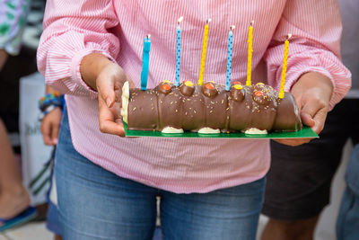 Midsection of woman holding ice cream