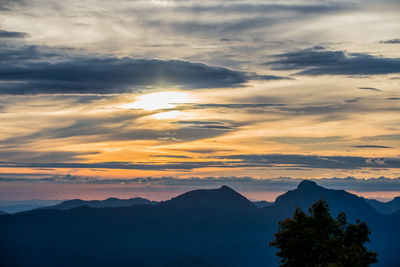 Scenic view of silhouette mountains against sky at sunset