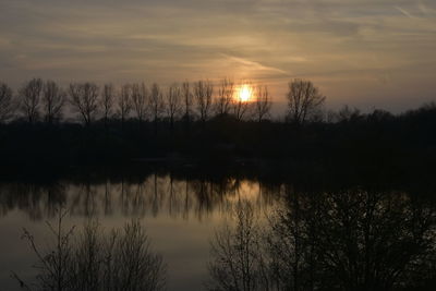 Scenic view of lake against sky during sunset