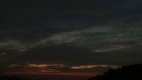 Low angle view of storm clouds at sunset