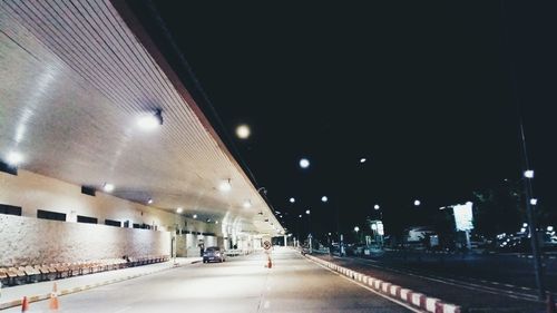 Illuminated tunnel at night