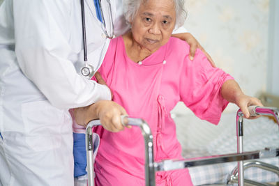 Portrait of female doctor examining patient in hospital