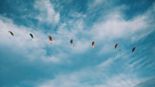 Low angle view of kites flying in sky