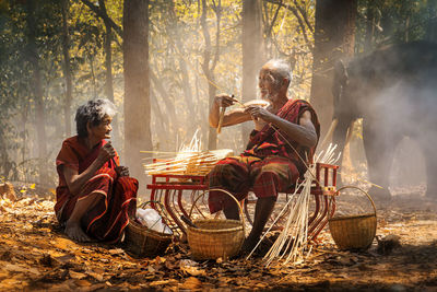 People in traditional clothing at forest