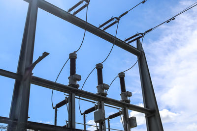 Low angle view of electricity pylon against sky