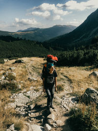 Man standing on mountain against sky