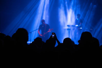 Silhouette people at music concert