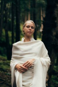 Portrait of woman standing in forest