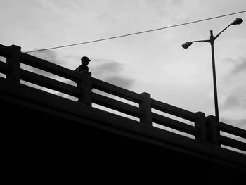 Low angle view of silhouette bridge against sky