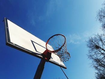 Low angle view of basketball hoop against clear blue sky