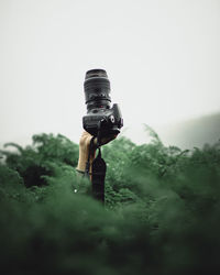 Close-up of camera on field against sky