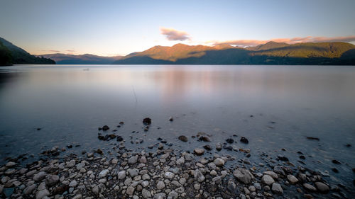 Scenic view of lake against sky during sunset