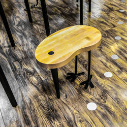 High angle view of yellow lamp on wooden table