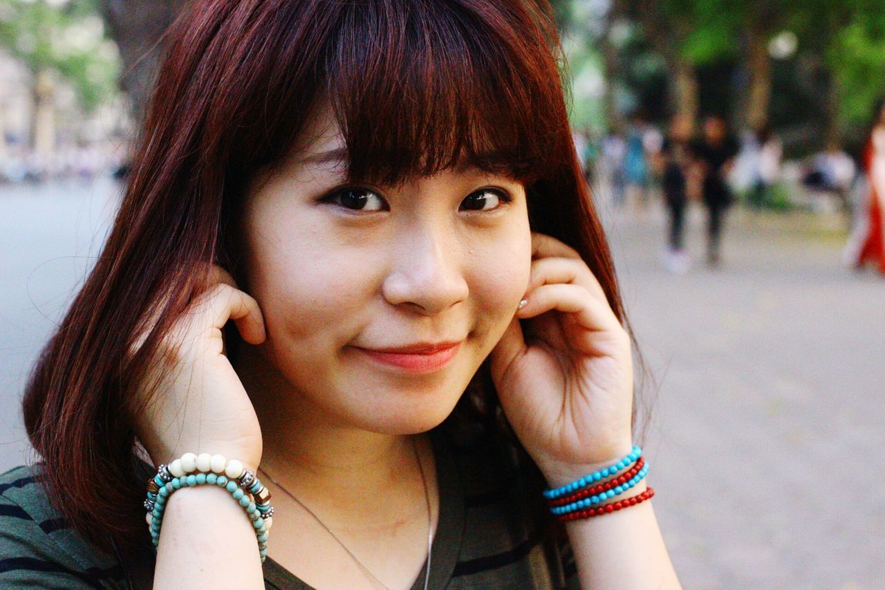 person, portrait, looking at camera, headshot, lifestyles, focus on foreground, front view, childhood, close-up, leisure activity, smiling, girls, happiness, young women, elementary age, young adult, cute, toothy smile