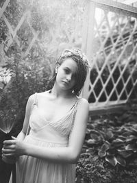 Portrait of young woman standing outdoors