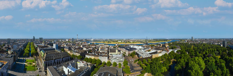 High angle view of buildings and sea against sky