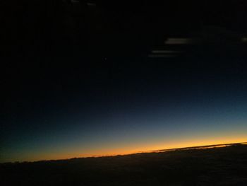 Silhouette landscape against clear sky at night