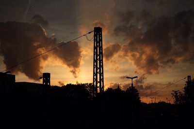 Low angle view of crane at sunset