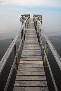 Pier over sea against sky