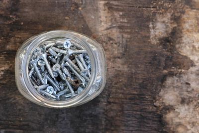 Directly above shot of nuts in jar on wooden table