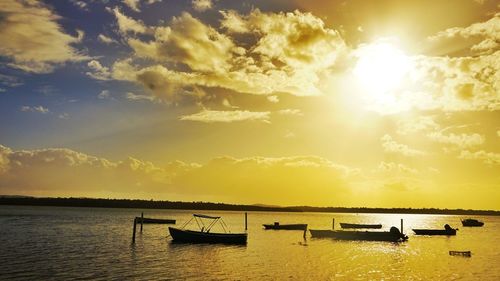 Boat in sea at sunset