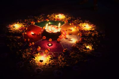 Close-up of lit candle in dark room
