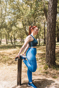 Full length of young woman standing at park