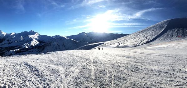 Scenic view of snow covered mountains against sky