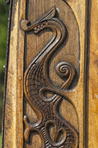 Wood carving of a dragon on a viking boat