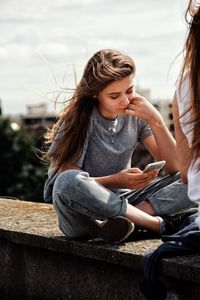 Young woman sitting outdoors