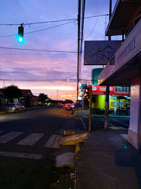 Cars on illuminated street at dusk