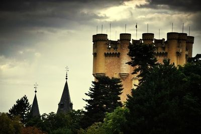 Low angle view of building against cloudy sky