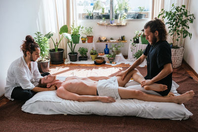 Men massaging customer at spa